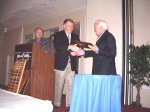 Admiral Receives a Plaque from Westerberg as Rufus looks on.